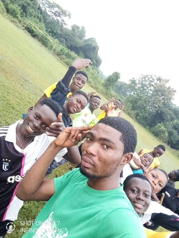 Richard with a group of students on the field